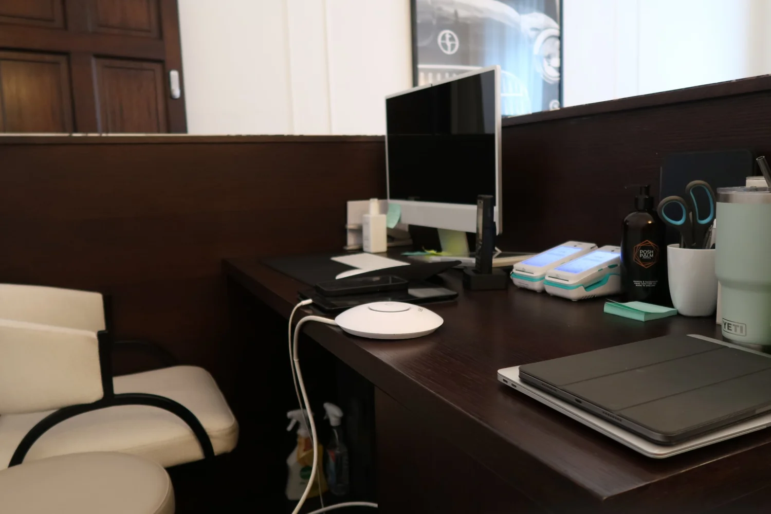 Reception workstation with a WiFi access point on the desk at Harley Street Injectables